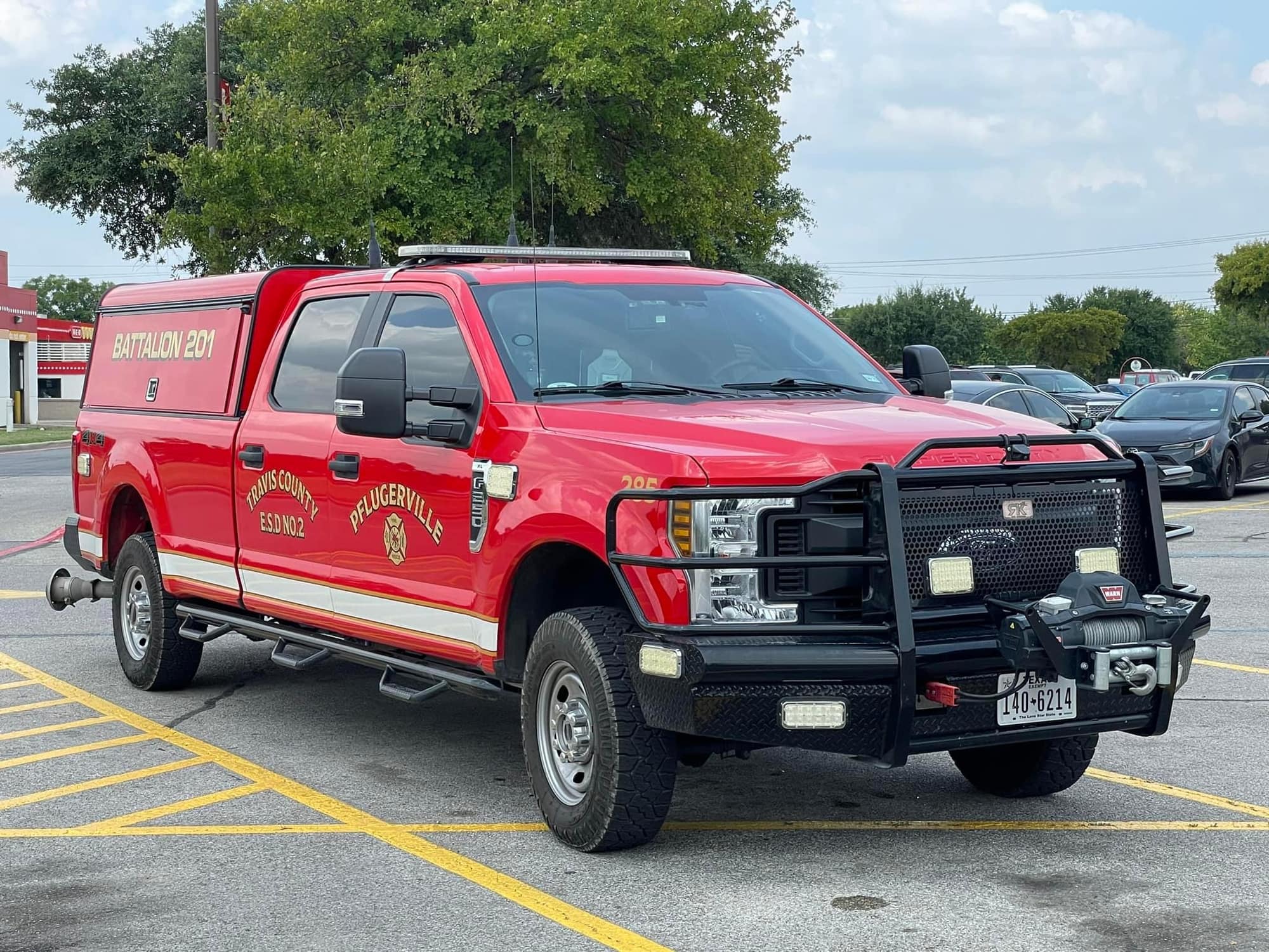 Red Pflugerville Fire Department Battalion 201 command pickup parked in an outdoor lot.