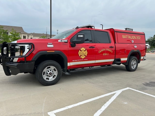 Red Pflugerville Fire Department Batt 202 command pickup parked in a marked lot.