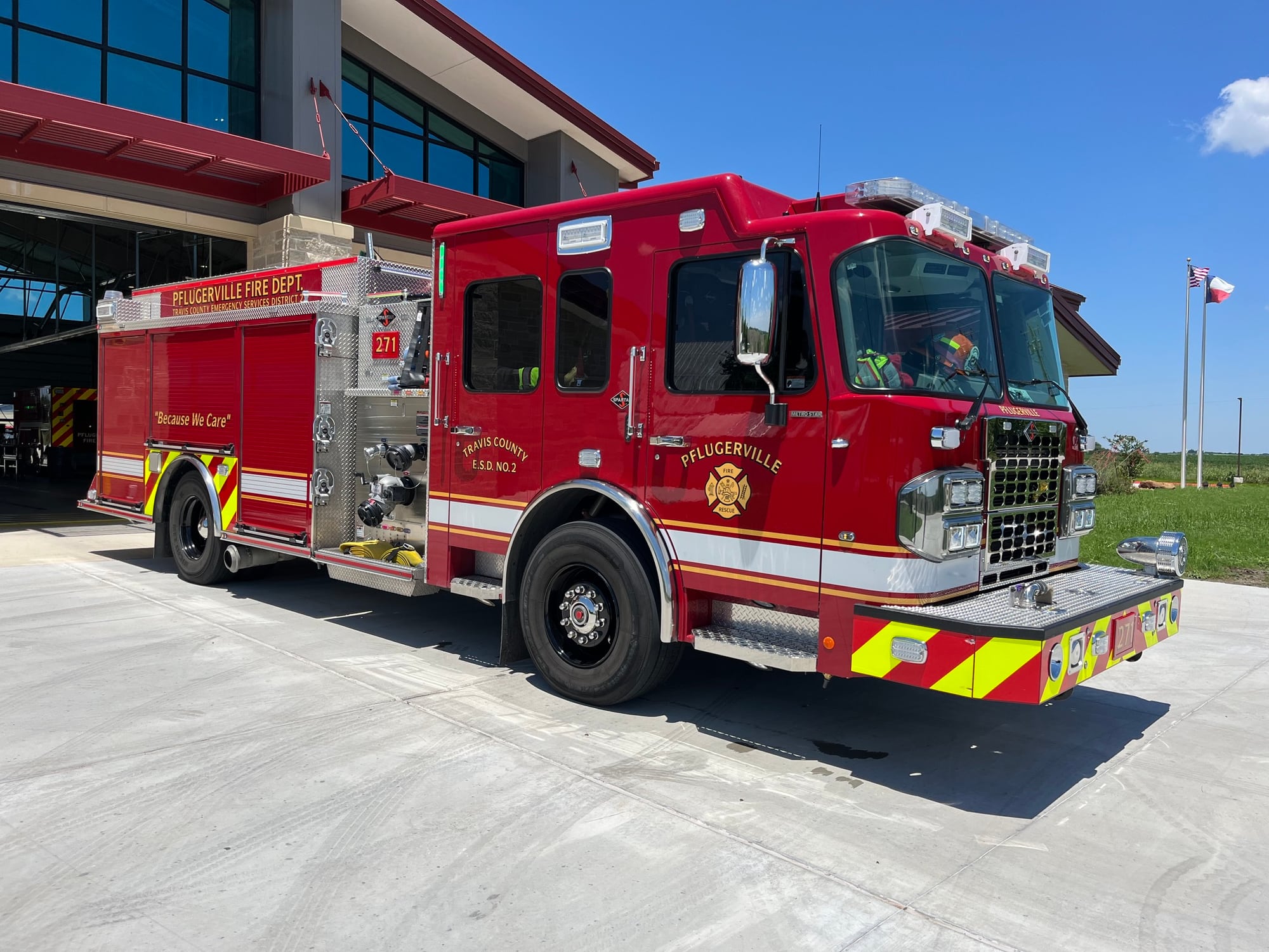 Red Pflugerville Fire Department Engine 271 pumper parked on a station driveway.