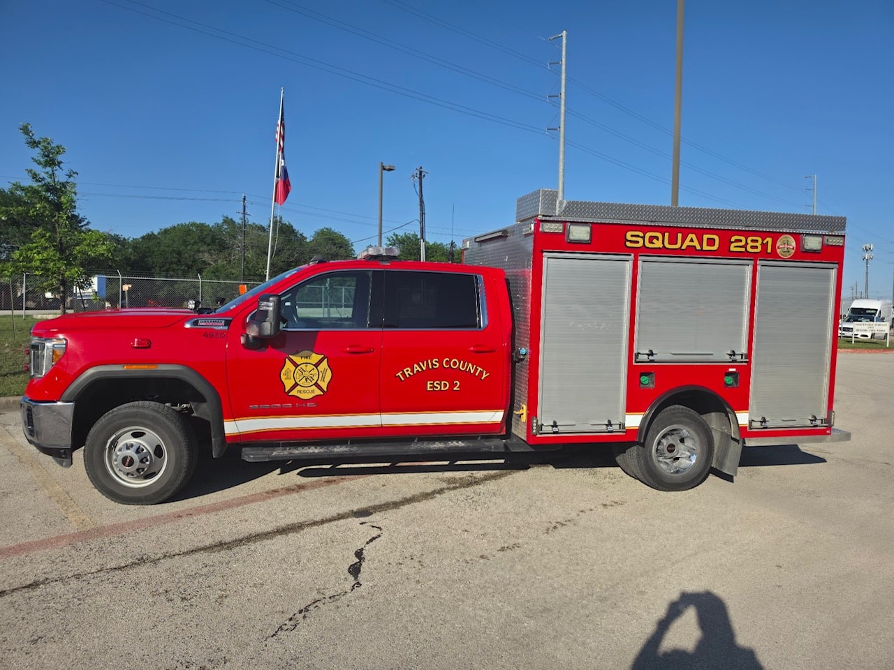 Red Pflugerville Fire Department Squad 281 utility truck parked along a curb.